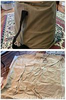 Tan fabric storage/transport bag with black strap standing upright on patterned rug.