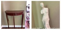 Photo showing the wooden entranceway table and the plaster statue sculpture side by side against a wall.
