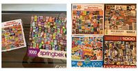 Photo showing six puzzles total with close-up of overall box fronts, verifying six 1000 piece assorted puzzles.