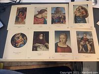 First photo of eight (8) unframed reproduction prints showing various classical artwork depictions by Raffaello. Prints are on uncut larger sheets of paper approximately 6 x 8 inches each.