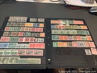 Two pages of a Hasper stamp album holding multiple rows of old Canadian stamps, mostly mint with some used. Various colors and denominations visible.