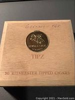 Wooden cigar box closed with handwritten text 'Germany FGR' on top and Ritmeester branding.