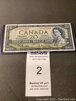 Front view of the 1954 Canadian twenty dollar bill showing Queen Elizabeth II portrait, serial #7015263, signatures, and denomination markings inside a plastic sleeve.