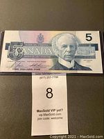 Front image of 1986 Canadian five dollar bill showing the portrait of Sir Wilfrid Laurier, denomination, and security features.