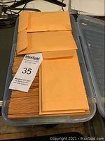 Stack of approximately 300 manila envelopes containing stamps, some with Auction lot tag #35