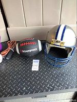 Football helmet, Kampro football shown on black textured surface.