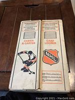 Front exterior of white cardboard card locker showing NHL shield, hockey player graphic, bilingual “CARD LOCKER / CASIER À CARTES” text