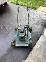 Front view of Craftsman Eager 1 lawnmower showing green deck, engine, wheels, and handle.