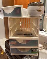 Plastic Stack-On drawers unit with missing drawers shown on a surface