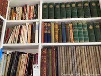 Bookshelves containing a diverse collection of vintage and antique books, with Time Life series green volumes prominently displayed.