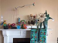 Overview of all items set on a mantel, including candleholders, figurines, and textiles.