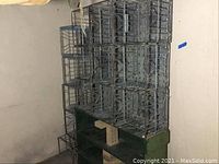 Stack of metal wire crates lashed together with wire and showing rust.
