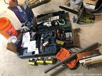 Open Hitachi hard case with Model CR13VBY reciprocating saw, Bosch drill, batteries, charger and parts on concrete floor