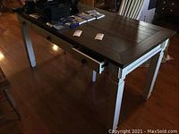 Full view of desk and matching chair from side, showing overall appearance and scale