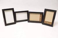 Four 4x6 black wood frames displayed upright showing front sides with photo placeholders inside.