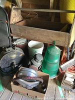 Full lot view showing green light channel marker buoy, red hanging light, wooden toolbox, and other tools.