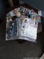 Photo showing hockey cards spread out with a baseball in the center