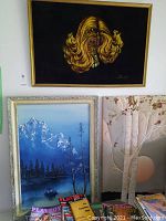 Overview shot showing all three paintings: top portrait, left mountain scene, right birch tree scene