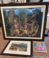 Overall view of three framed artworks displayed together on floor