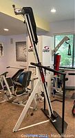 Full front view of the VersaClimber exercise machine assembled with frame, handlebars, and base plate.