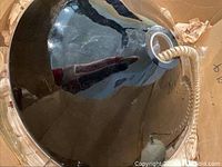 Top view of the black glass chandelier showing glossy finish and central hole with coil-wrapped electrical cord