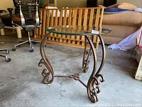 Clear view of the round glass top and metal curled legs of the end table.