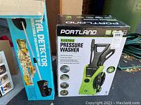 Two boxed items: Portland electric pressure washer and Radio Shack metal detector.
