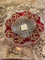 Top view showing decorative red and gold border with clear center of the glass bowl.