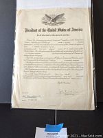 Official US Navy appointment document with eagle emblem, signatures, embossed seal, dated 1947, showing some creasing and wrapping protective sleeve.