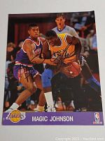 Full view of the 8x10 signed photo showing Magic Johnson in Lakers uniform actively playing basketball and signature across the image.