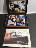 Slipcase opened showing two VHS tapes in decorative bindings and collector's book placed in front