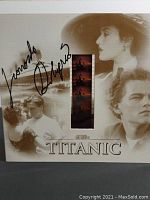 Front view of the Titanic themed card with embedded film strip and Leonardo DiCaprio autograph covering the card and images of movie scenes.
