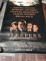 Full view of the promotional movie poster showing the cast names and signature area.