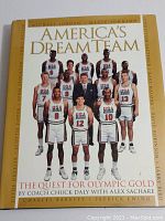 Front cover of the book showing the 1992 USA Dream Team basketball players with yellow spine and title.