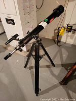 Side view of the full telescope mounted on tripod showing length and setup.