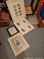 Image showing six art prints: one with seven teapots and five floral prints, along with a dark wood photo frame and a larger white frame with floral print.