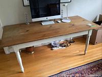 Full view of the vintage harvest table showing natural pine top and white painted base with turned legs.