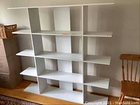 Front view of white MDF bookcase with multiple shelves and no back panel.