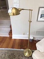 Full view of lamp showing weighted round base, straight pole and dome shade at full height