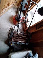 Full view of the American reel mower showing frame and wheels.