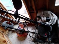 Photo of Toro 15 inch brass trimmer showing its metal frame, black handle, and visible wear marks.