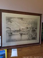 Full framed harbor scene print showing steamship, smaller boats, and architecture along waterfront with cloudy sky and beam of light.