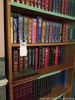 Bookshelf with assorted hardcover novels in classic bindings, including Reader's Digest collections and literary classics.