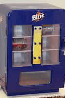 Front view of blue Labatt's Blue mini fridge with glass door, yellow vertical bar, and cans inside
