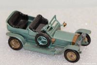 Front-side view of green 1907 Rolls Royce Silver Ghost model car showing detailed seats, spare tire, and front grill with gold accents.