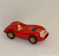 Red 1960s slot car angled view showing driver figurine and front decal