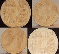 Four collector plates arranged together showing different religious scenes with detailed bas-relief sculpture in alabaster style.
