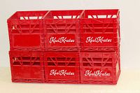 Six small red plastic lattice crates stacked in two rows of three, each marked with white 'Kool Krates' branding on side panels.