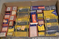 A box filled with over 30 original cardboard boxes containing vintage radio parts from brand Mallory, including volume controls and potentiometers. Some boxes are empty.