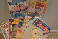 Wide view showing comic books including Spooky, Donald Duck, Tweety Bird, The Jetsons, and other assorted titles with colorful front covers.